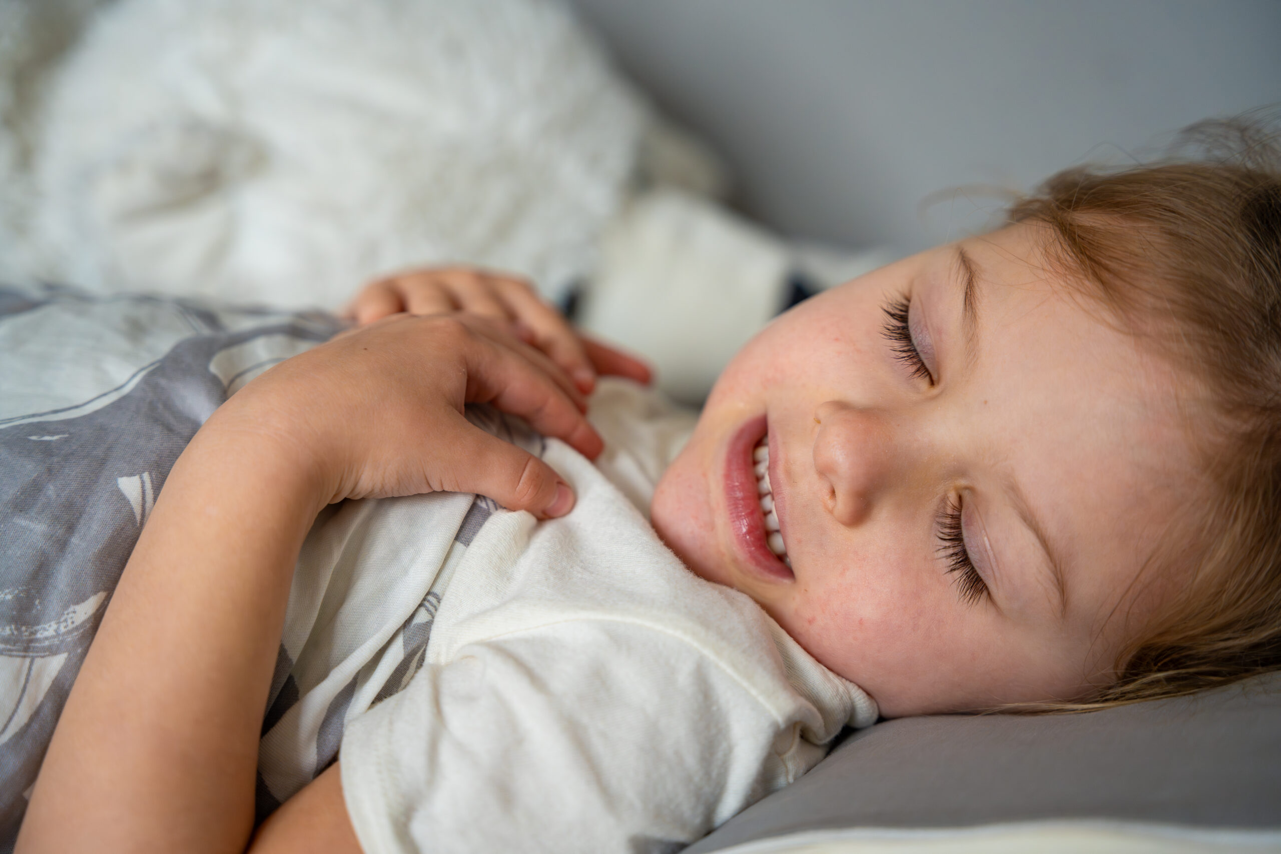 Cute little girl sleeping and grinding teeth in dreams, clenched teeth with tiredness and stress. High quality photo