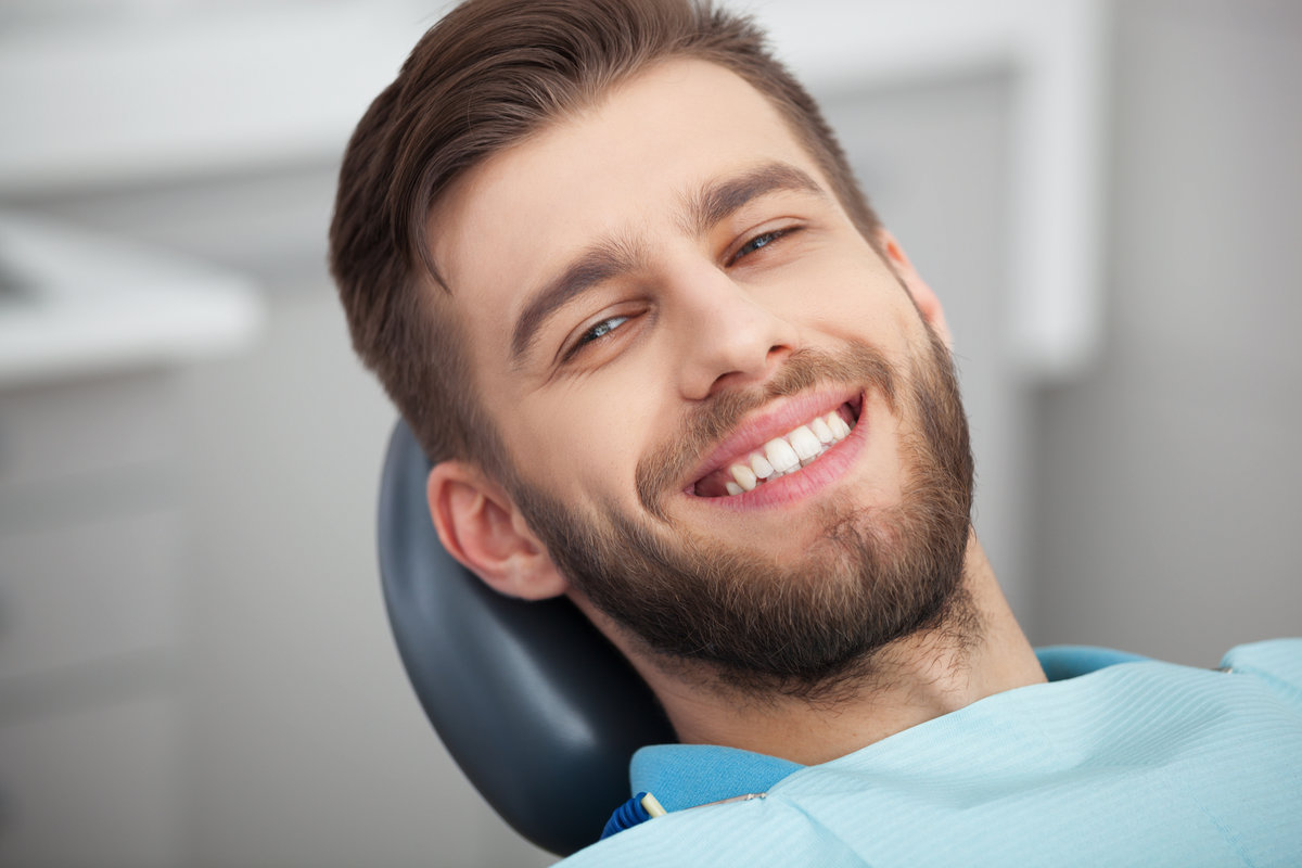 My smile is perfect! Portrait of happy patient in dental chair.